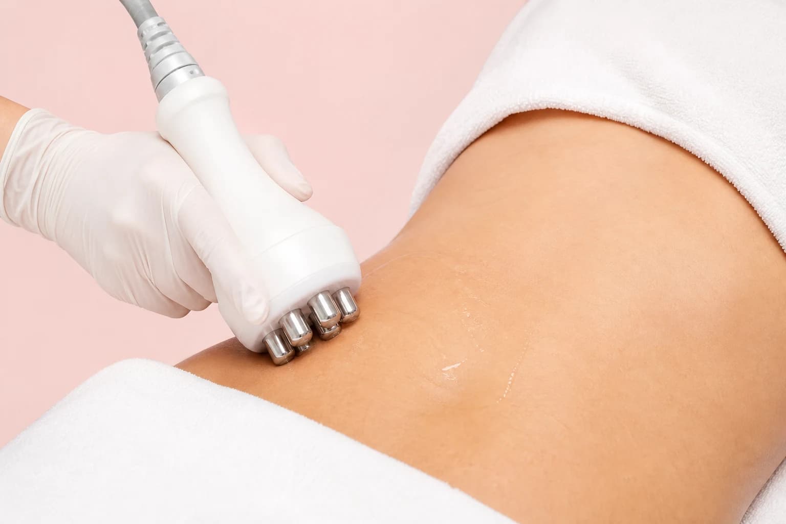 Illustrative treatment photography: A body-contouring handpiece applied to the abdomen